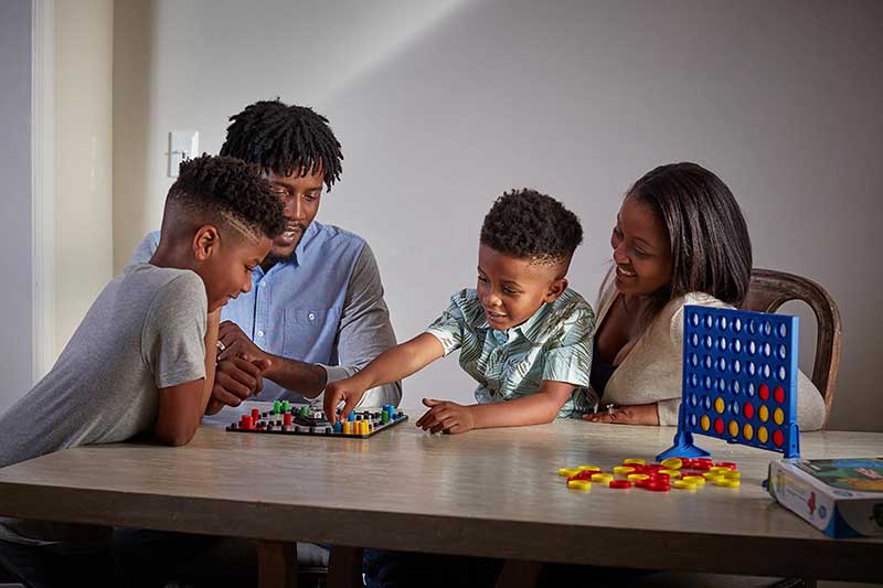 family playing board game together